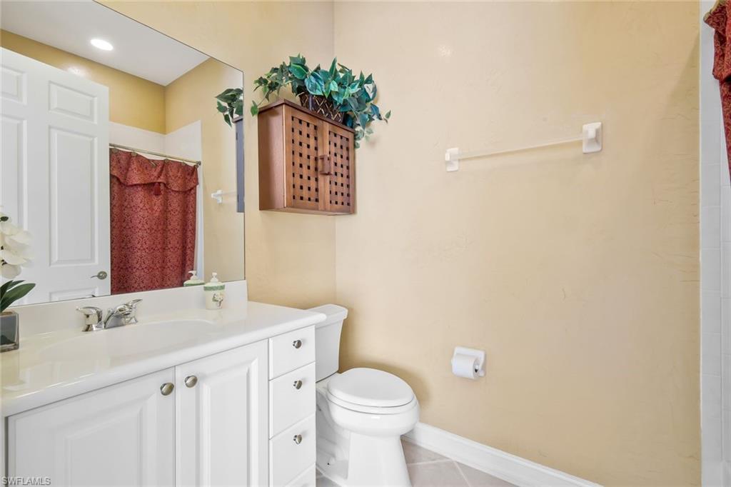 5025 Blauvelt Way, Unit 202 Naples, FL 34105 - Photo 16 of 26 a bathroom with a sink toilet and vanity