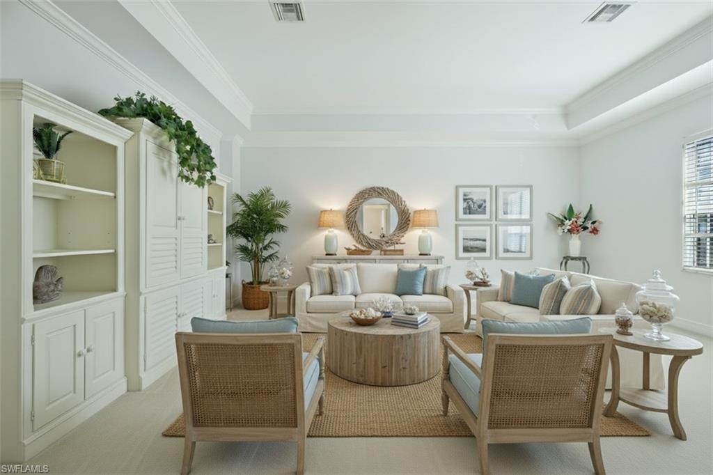5025 Blauvelt Way, Unit 202 Naples, FL 34105 - Photo 4 of 26 a living room with furniture a fireplace and a potted plant