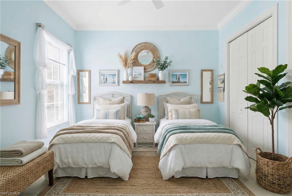 5025 Blauvelt Way, Unit 202 Naples, FL 34105 - Photo 5 of 26 a bedroom with two beds and a potted plant