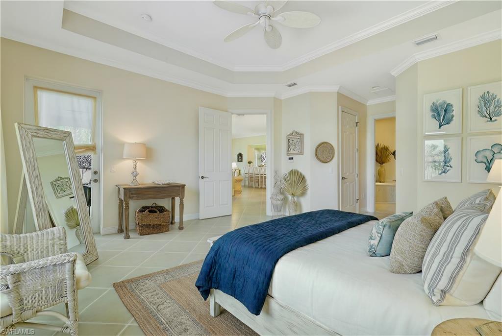 5025 Blauvelt Way, Unit 202 Naples, FL 34105 - Photo 6 of 26 a bedroom with a large bed and a fireplace