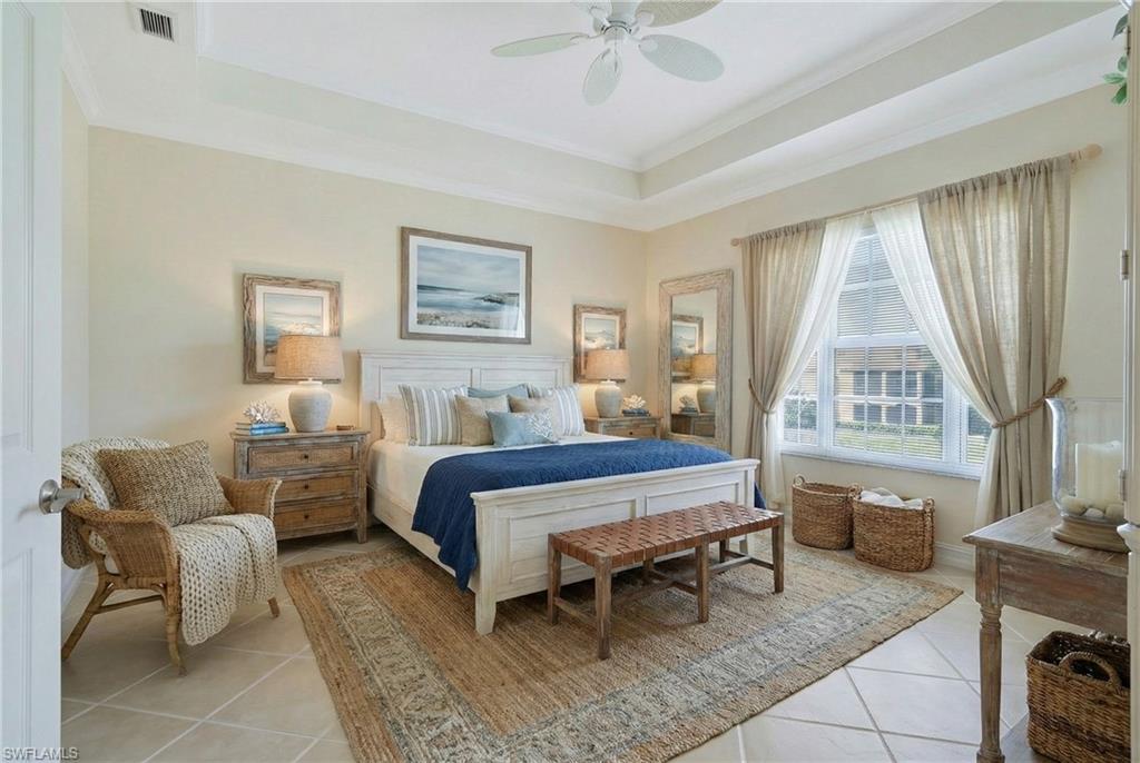 5025 Blauvelt Way, Unit 202 Naples, FL 34105 - Photo 7 of 26 a bed room with a bed and a couch