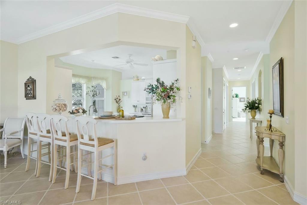 5025 Blauvelt Way, Unit 202 Naples, FL 34105 - Photo 10 of 26 a view of a dining room with furniture and a chandelier