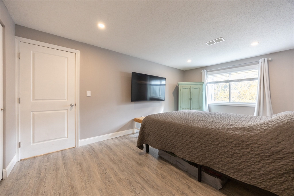 605 Franklin Crossing Road, Unit 605 Franklin, MA 02038 - Photo 12 of 31 a bedroom with a bed and a flat screen tv