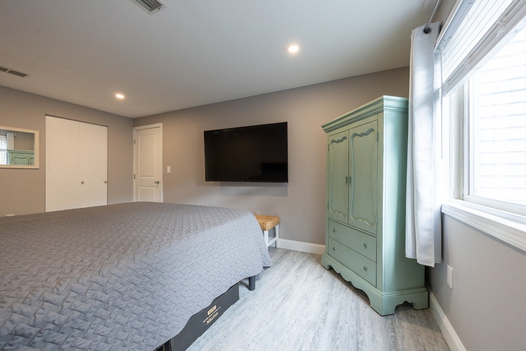 605 Franklin Crossing Road, Unit 605 Franklin, MA 02038 - Photo 15 of 31 a bedroom with a bed and a flat screen tv