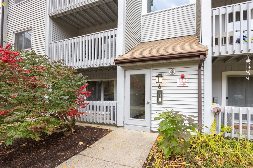 605 Franklin Crossing Road, Unit 605 Franklin, MA 02038 - Photo 22 of 31 a view of a house with a small yard and flower plants