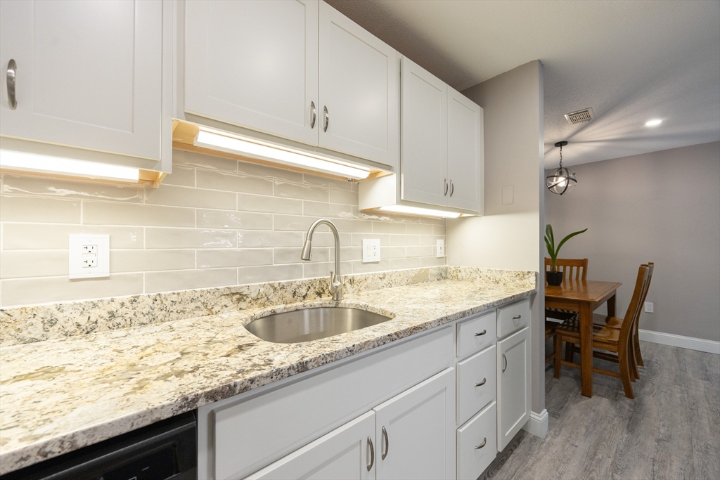 605 Franklin Crossing Road, Unit 605 Franklin, MA 02038 - Photo 9 of 31 a kitchen with a sink and cabinets