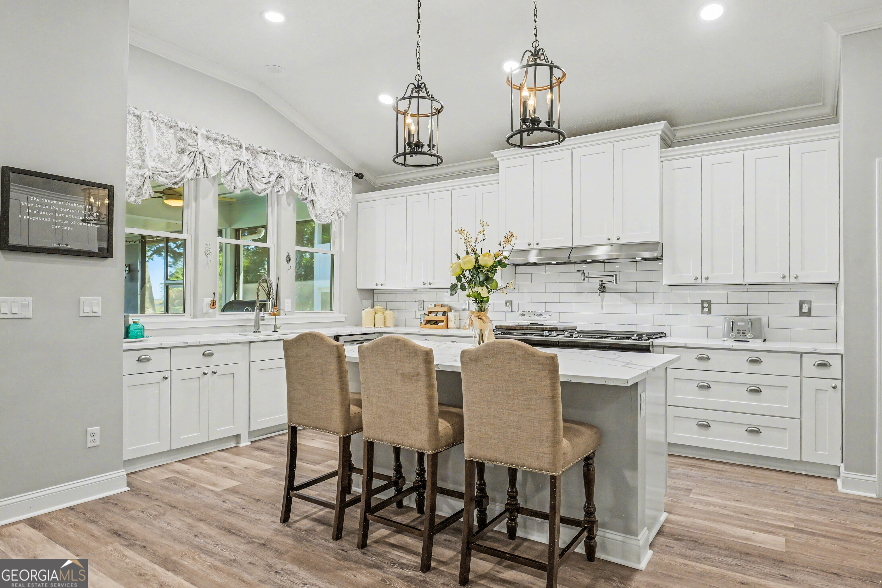 97222 Pirates Point Road Yulee, FL 32097 - Photo 14 of 82 a kitchen with stainless steel appliances granite countertop a stove a sink dishwasher a dining table and chairs with wooden floor