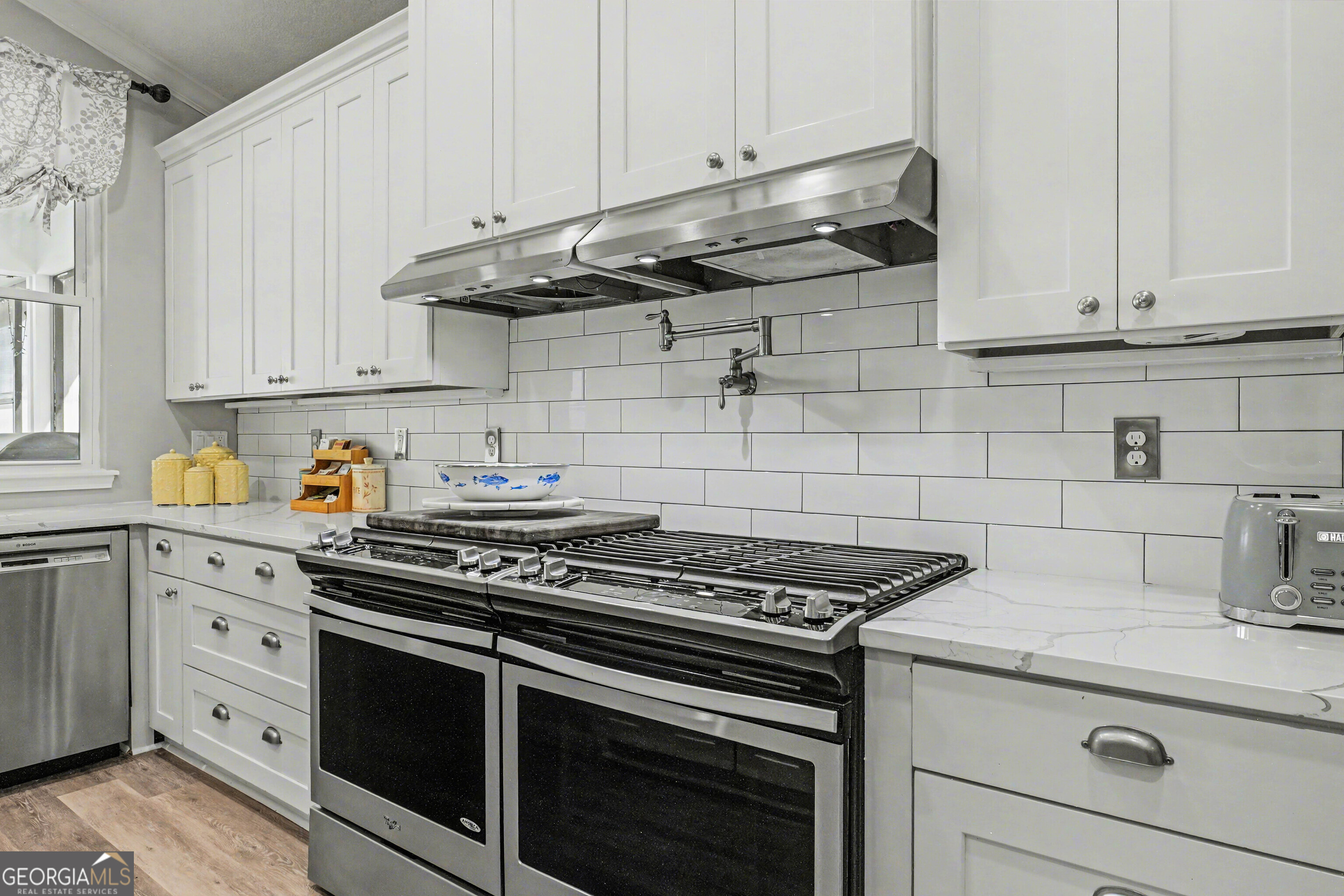 97222 Pirates Point Road Yulee, FL 32097 - Photo 17 of 82 a kitchen with granite countertop white cabinets and stainless steel appliances