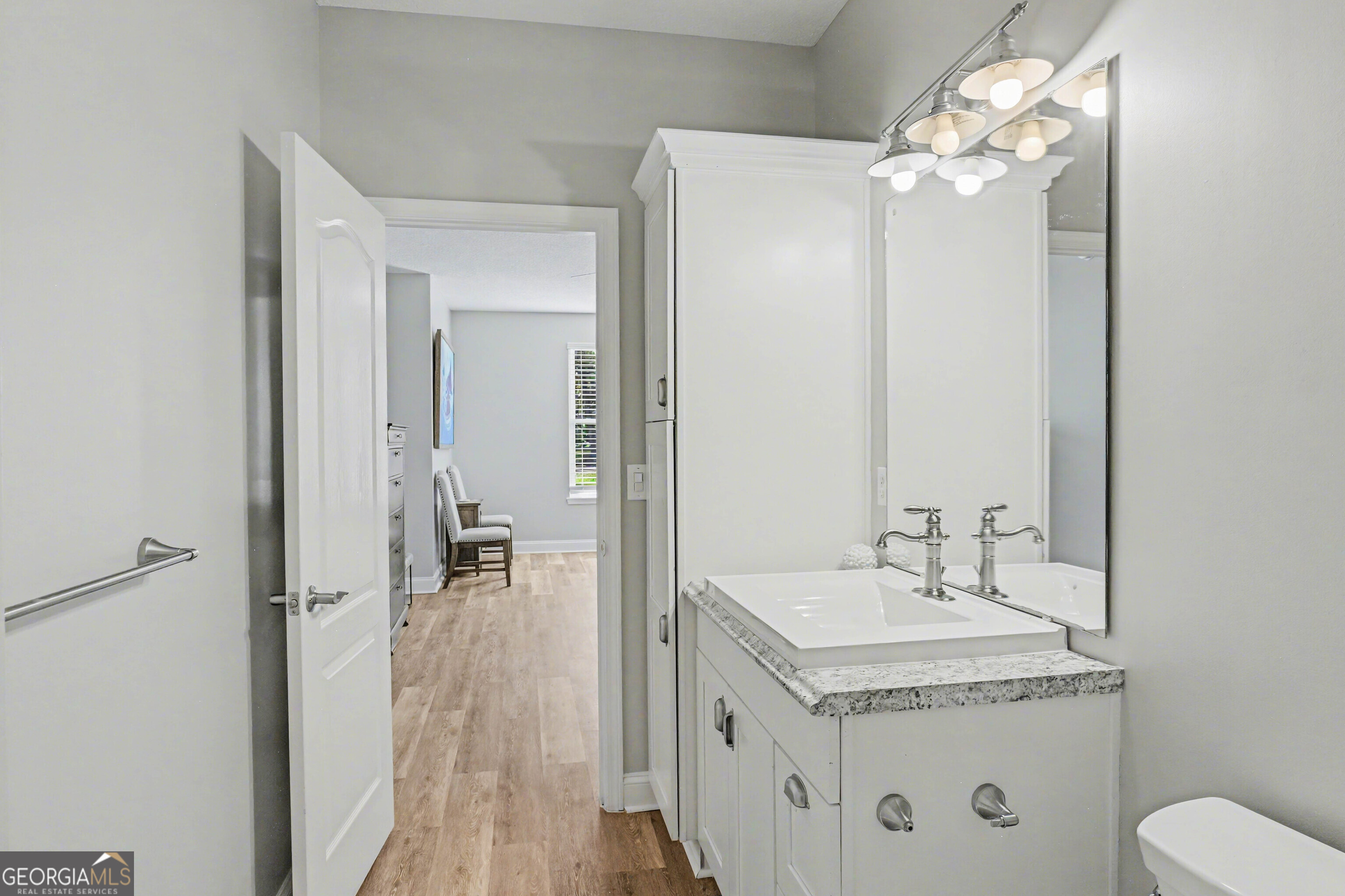 97222 Pirates Point Road Yulee, FL 32097 - Photo 41 of 82 a bathroom with a granite countertop sink a toilet and a mirror