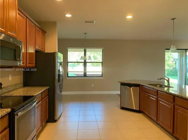 a kitchen with a stove microwave and refrigerator
