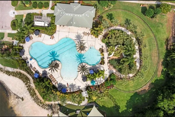 a view of a swimming pool with a patio and a garden