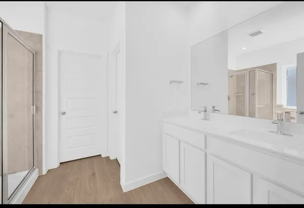 a bathroom with a double vanity sink and mirror