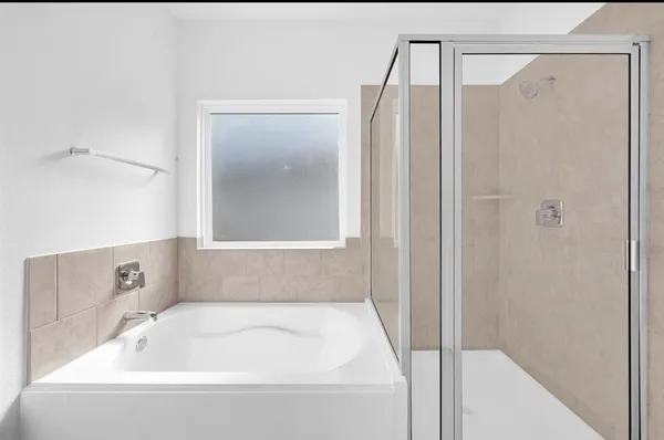a bathroom with a tub and shower