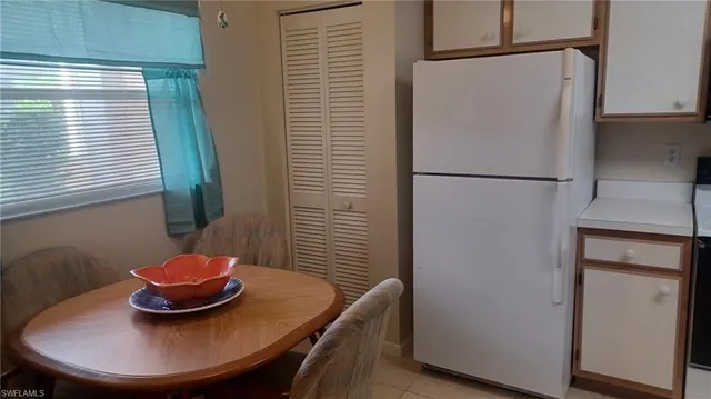 a kitchen with a refrigerator and a more window