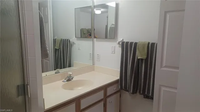 a bathroom with a sink a mirror and a shower
