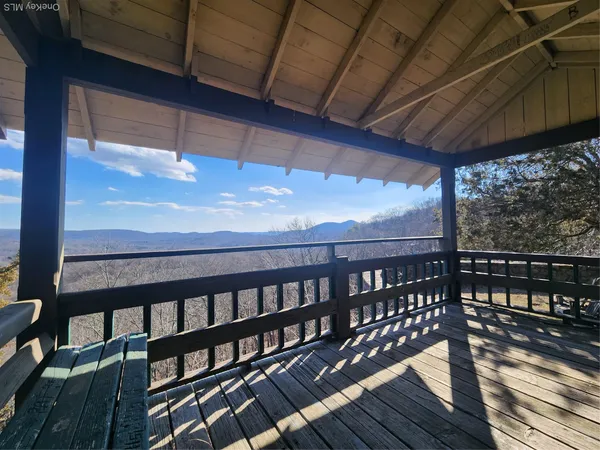 a view of a balcony with wooden floor