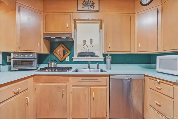 a kitchen with granite countertop a sink and cabinets