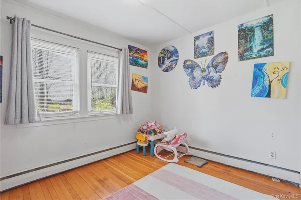 a room with furniture and paintings on the wall