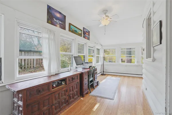 a view of a kitchen with stainless steel appliances granite countertop a stove and a wooden floors