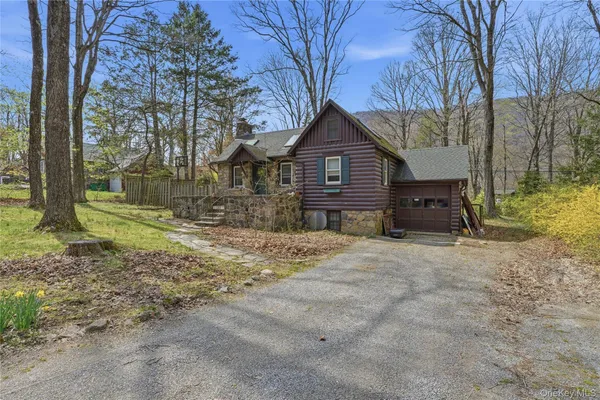 a view of a house with a yard covered in snow