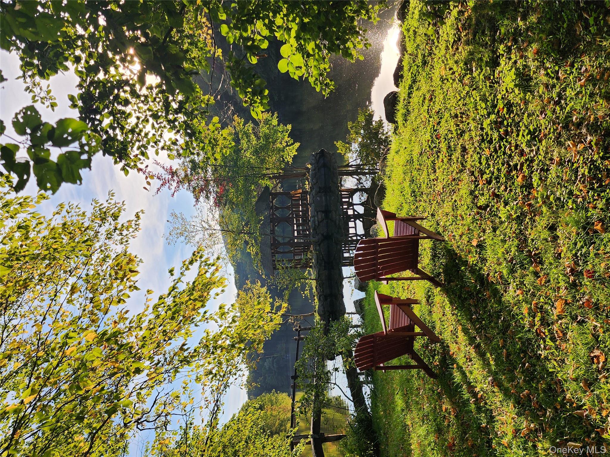167 Highland Road Cold Spring, NY 10516 - Photo 8 of 11 a view of a swimming pool with a bench and some trees