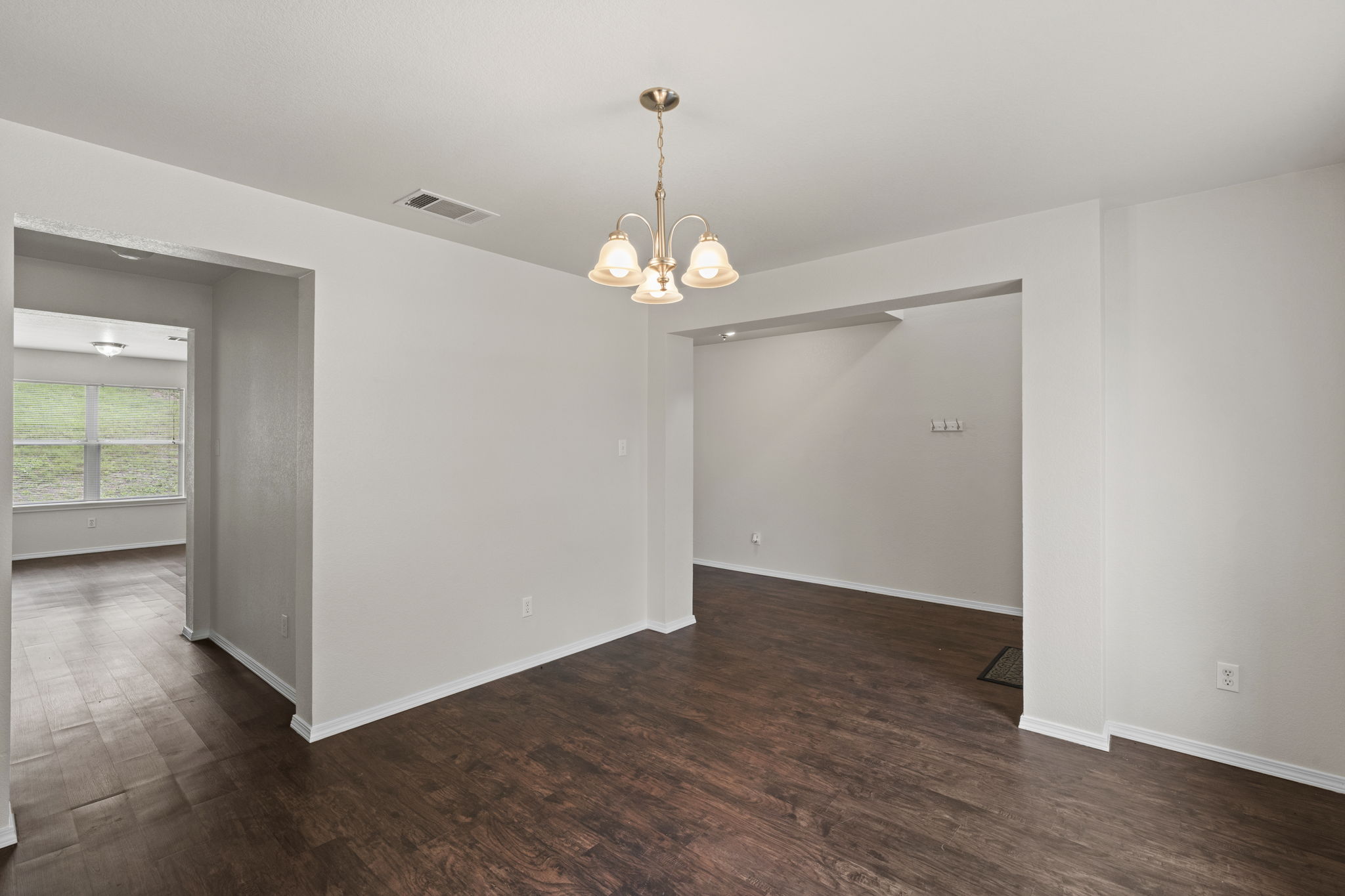 208 Dandelion Loop Kyle, TX 78640 - Photo 11 of 39 Dining room with access to kitchen. Light-colored walls throughout