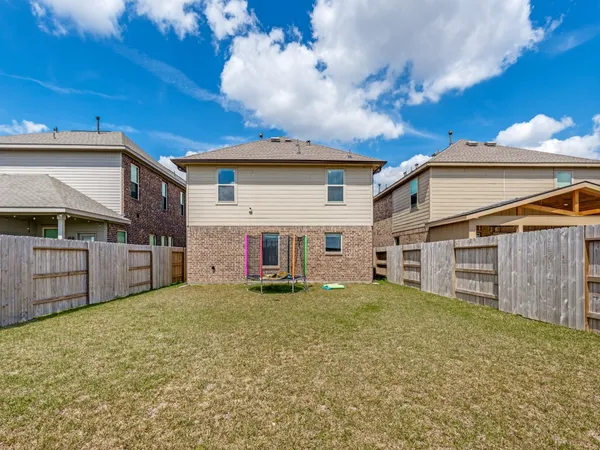 a view of a house with a big yard and a large tree