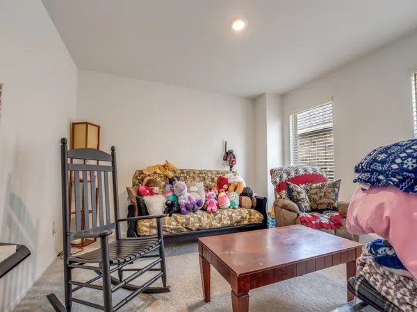a view of a dining room with furniture and toys