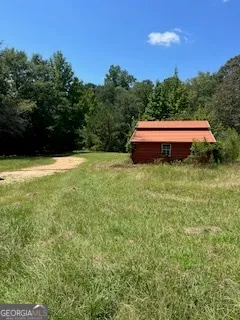 a backyard of a house with yard and trampoline