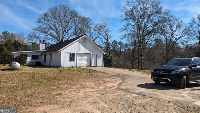 a house view with a car parked in front of house