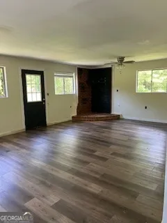 wooden floor in an empty room with a window