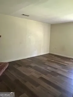 an empty room with wooden floor