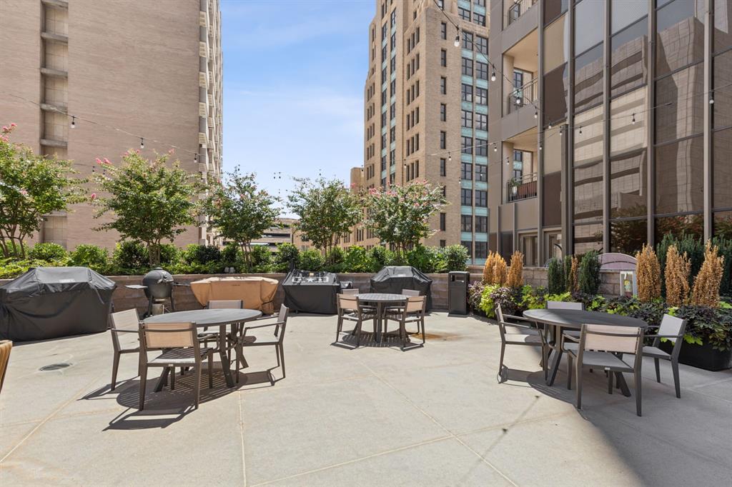 1200 Main Street, Unit 2302 Dallas, TX 75202 - Photo 22 of 22 a view of a patio with a table and chairs and potted plants