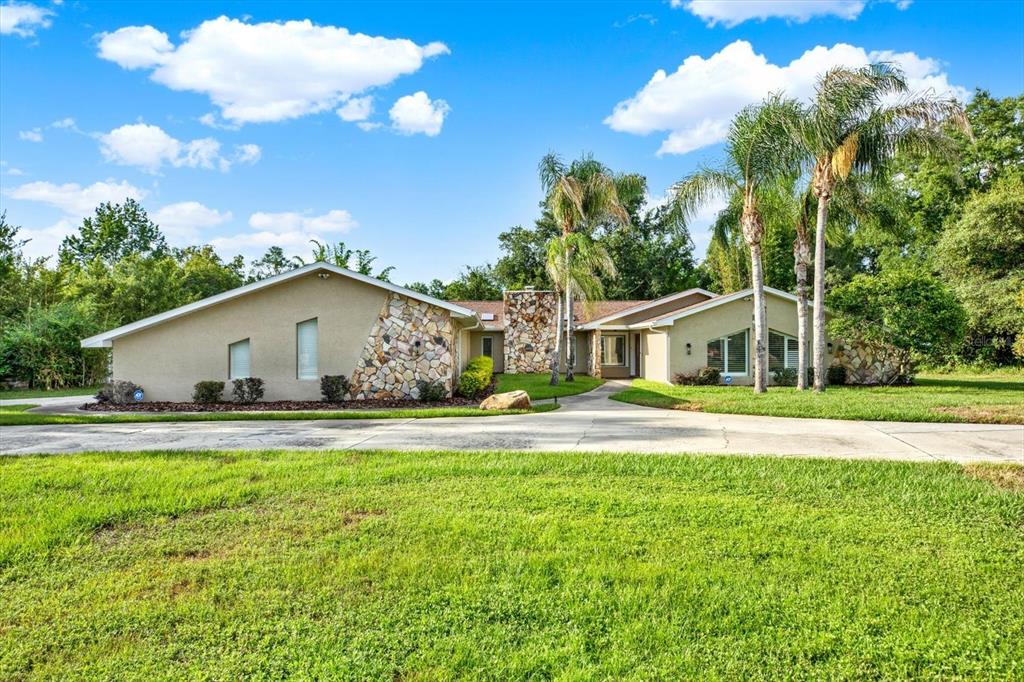7487 River Country Drive Weeki Wachee, FL 34607 - Photo 49 of 53 a front view of house with yard and trees around