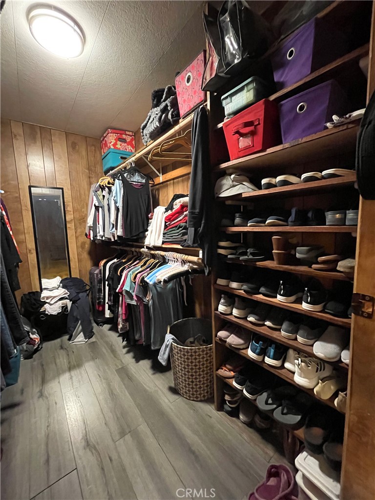 31348 North Lakehills Road, Unit 2 Castaic, CA 91384 - Photo 17 of 42 a view of walk in closet with clothes and shoes