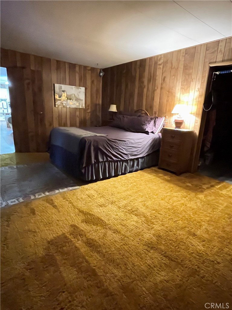 31348 North Lakehills Road, Unit 2 Castaic, CA 91384 - Photo 18 of 42 a bedroom with a bed and wooden floor