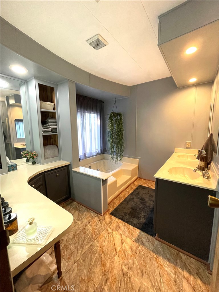 31348 North Lakehills Road, Unit 2 Castaic, CA 91384 - Photo 19 of 42 a spacious bathroom with a tub double vanity sink and a large mirror