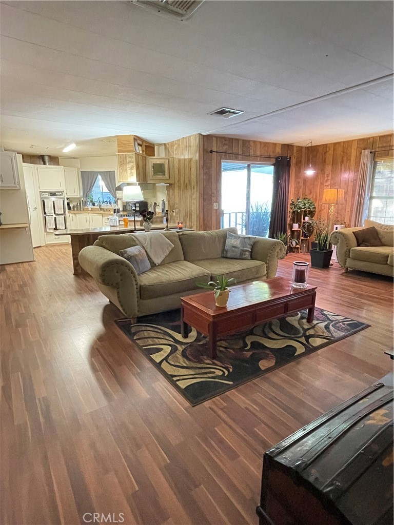 31348 North Lakehills Road, Unit 2 Castaic, CA 91384 - Photo 3 of 42 a living room with furniture hard wood floor and a large window