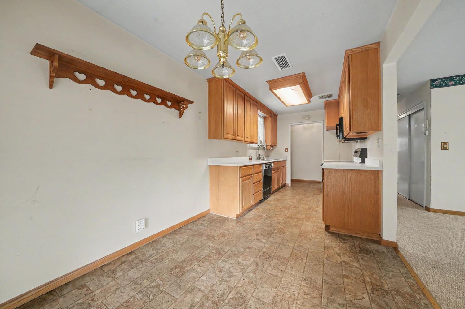 626 Sutter Lane Ione, CA 95640 - Photo 6 of 21 a kitchen with a refrigerator and a stove top oven