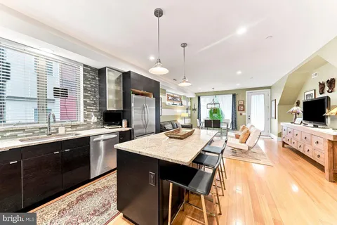 a large kitchen with kitchen island a sink and a stove