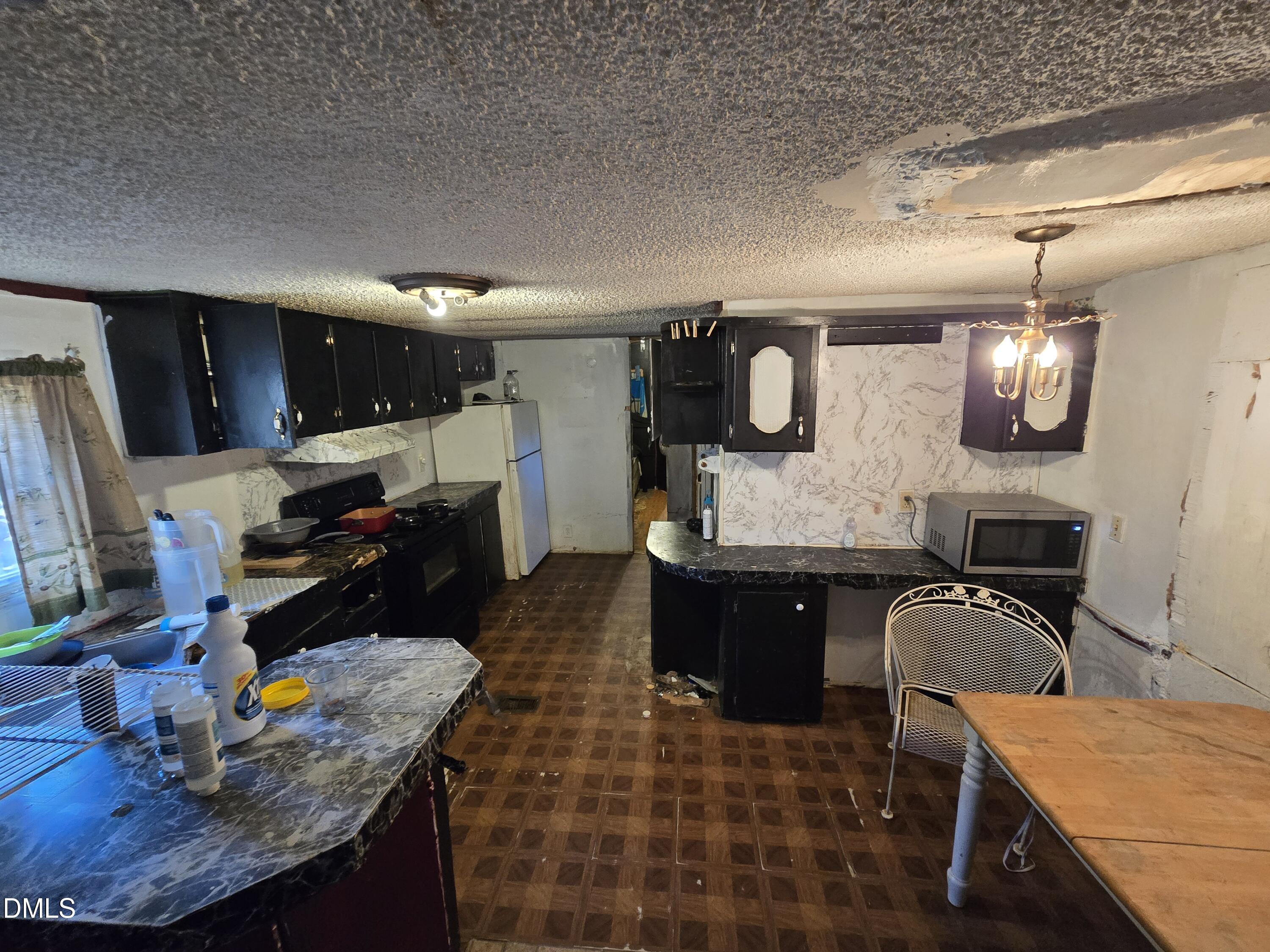 6782 Pinecrest Road Zebulon, NC 27597 - Photo 9 of 13 a kitchen with a sink appliances and cabinets