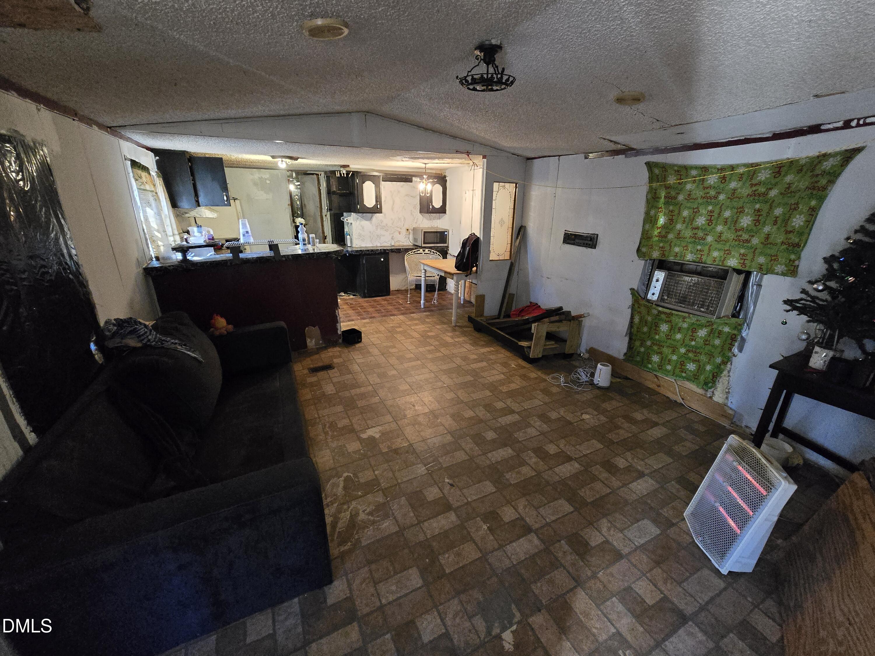 6782 Pinecrest Road Zebulon, NC 27597 - Photo 10 of 13 a living room with furniture and a large window