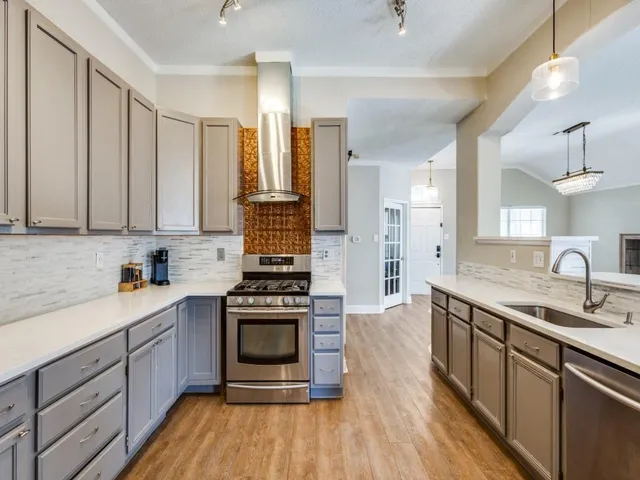 a kitchen with a sink stove and cabinets