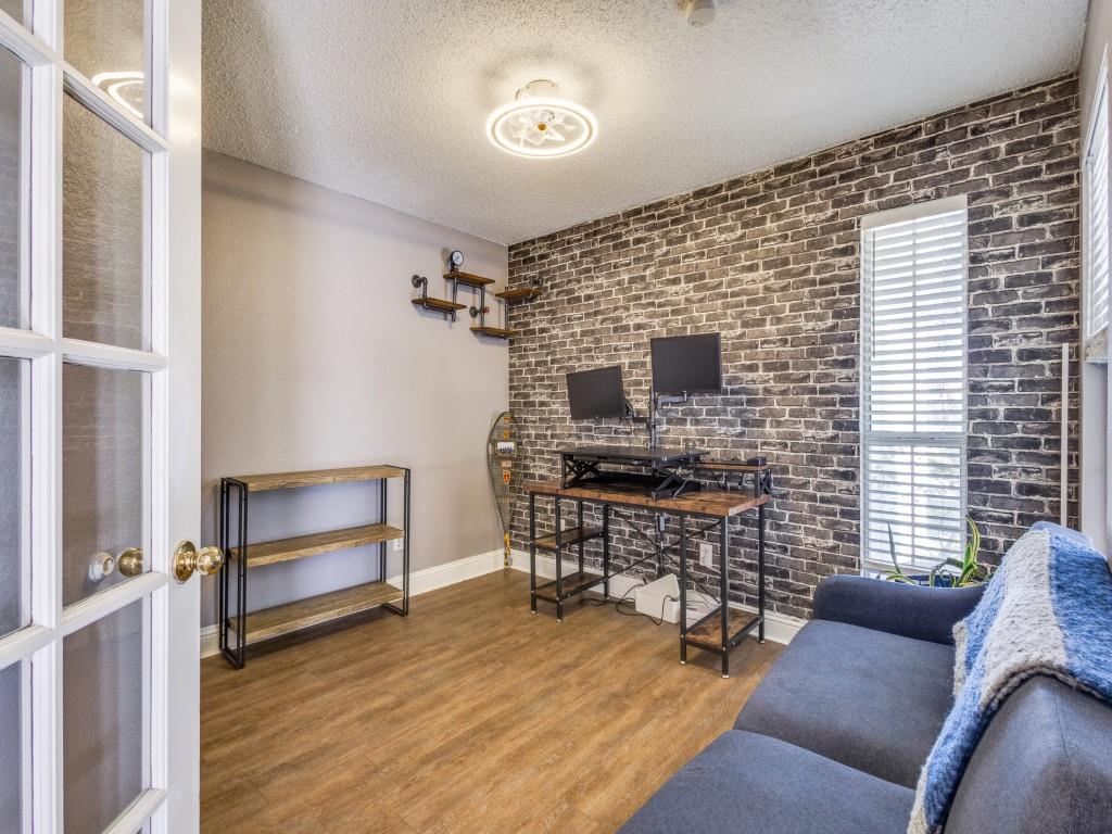 7129 Sample Drive The Colony, TX 75056 - Photo 15 of 25 Home office with brick wall, wood finished floors, and a textured ceiling