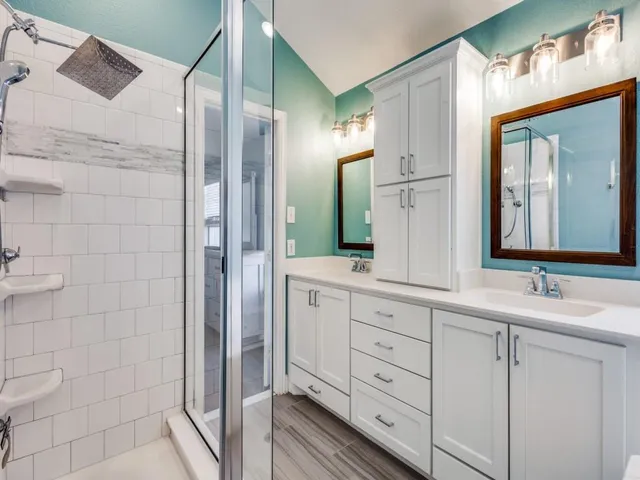 a bathroom with a double vanity sink and mirror