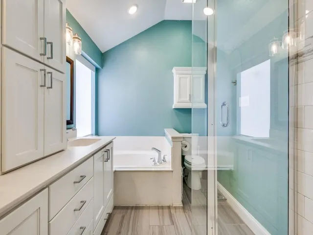 a spacious bathroom with a sink a mirror and a shower