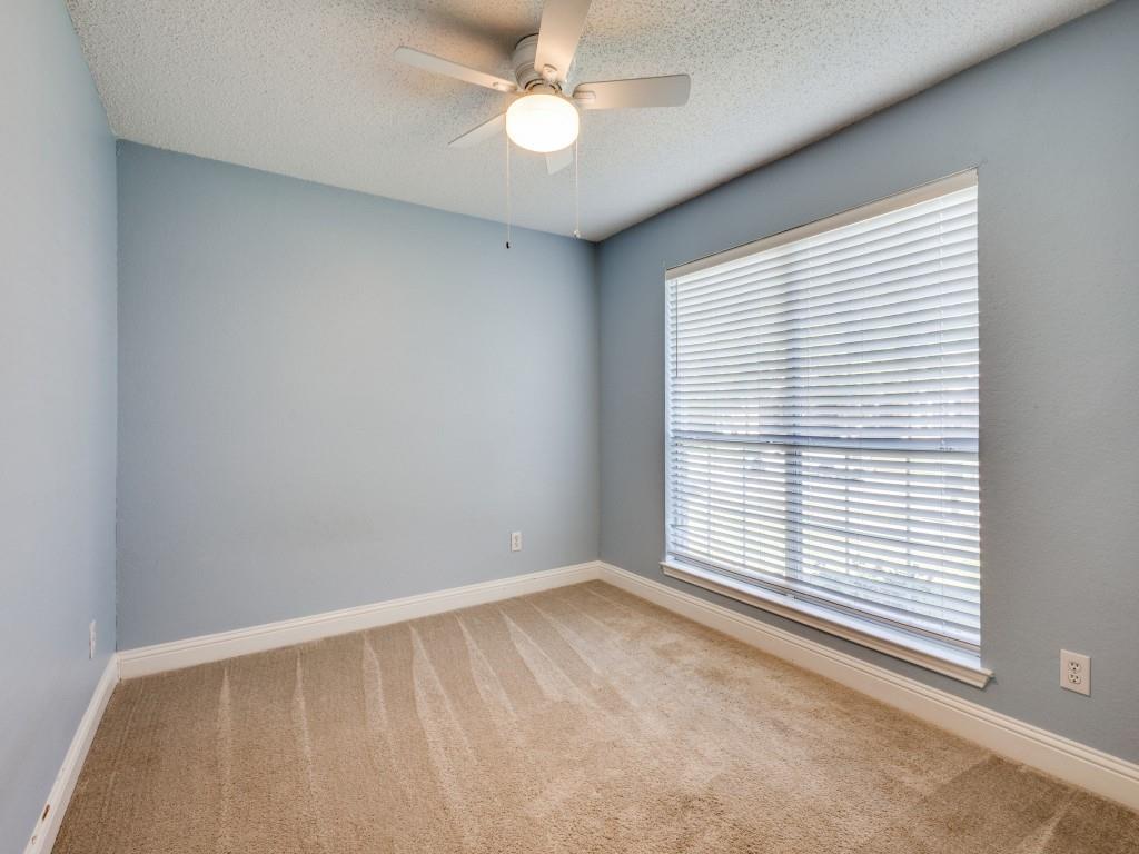 7129 Sample Drive The Colony, TX 75056 - Photo 21 of 25 Spare room with carpet, a textured ceiling, and a ceiling fan