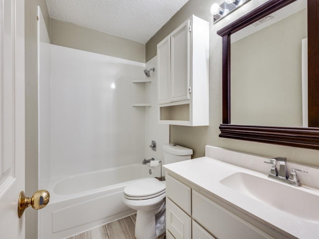 7129 Sample Drive The Colony, TX 75056 - Photo 22 of 25 Full bathroom with washtub / shower combination, a textured ceiling, vanity, and a textured wall