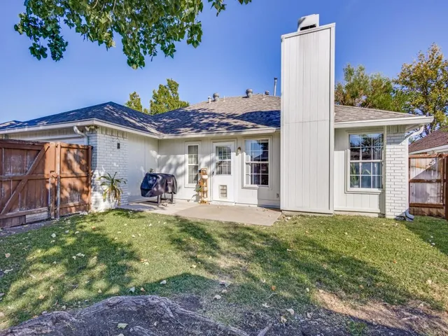a view of a house with backyard porch and sitting area