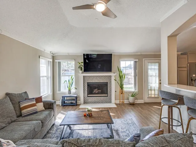 a living room with furniture fireplace and window